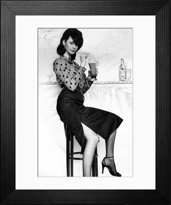 Framed Print : A model poses in a pencil skirt drinking a cocktail Framed Print : A model poses in a pencil skirt drinking a cocktail