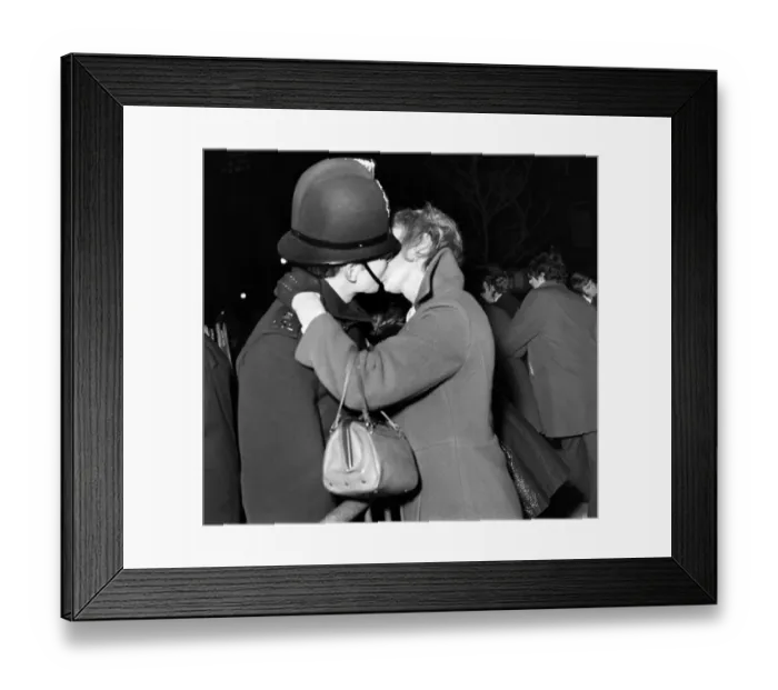 Framed Print : A woman kisses a policeman to celebrate New Year in Manchester