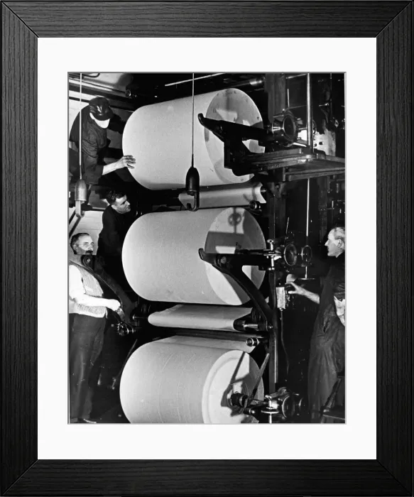 Framed Print : Printers Circa 1950 Reels of paper are loaded and threaded into the printing press