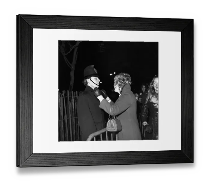 Framed Print : A woman kisses a policeman to celebrate New Year in Manchester