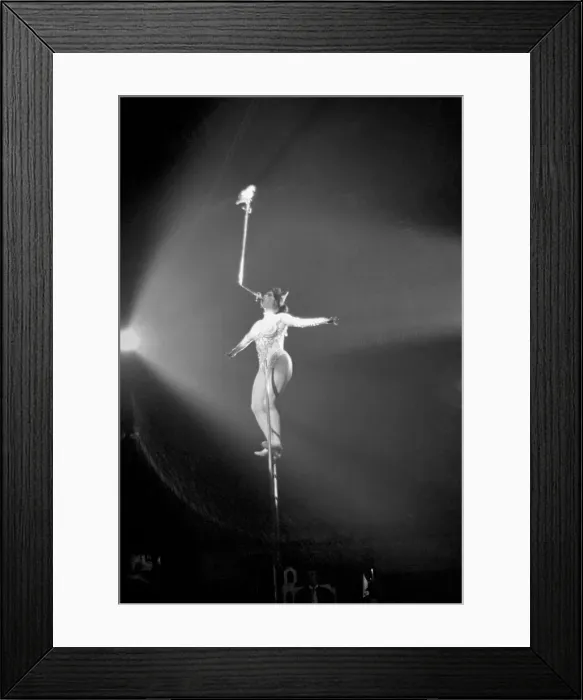 Framed Print : Miss Wendy performs her balancing act with a pigeon perched on the end of a sword during Framed Print : Miss Wendy performs her balancing act with a pigeon perched on the end of a sword during