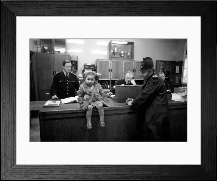 Framed Print : Police and Children. The scene is set in the enquiry office of Bishopsgate Police Station
