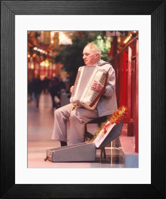 Framed Print : Busker Terry Larke playing his accordian in Cramlingtons shopping centre