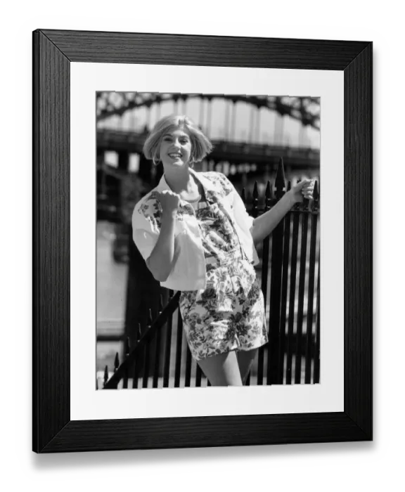 Framed Print : A model poses in the latest denim dungarees