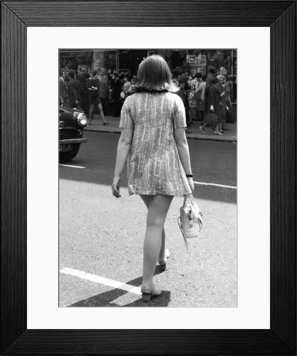 Framed Print : A young wearing a mini-mini dress in height of the swinging sixties