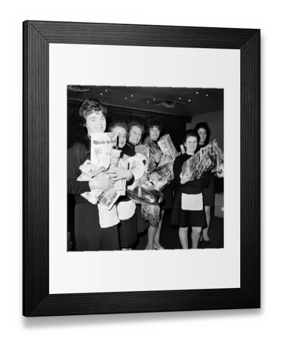 Framed Print : Holding presents they have bought with the rest of the banqueting staff at Skyway Airport