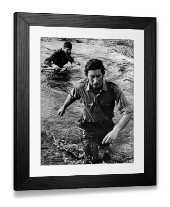 Framed Print : Running tall. Prince Charles wades along a stream. January 1975 P009343