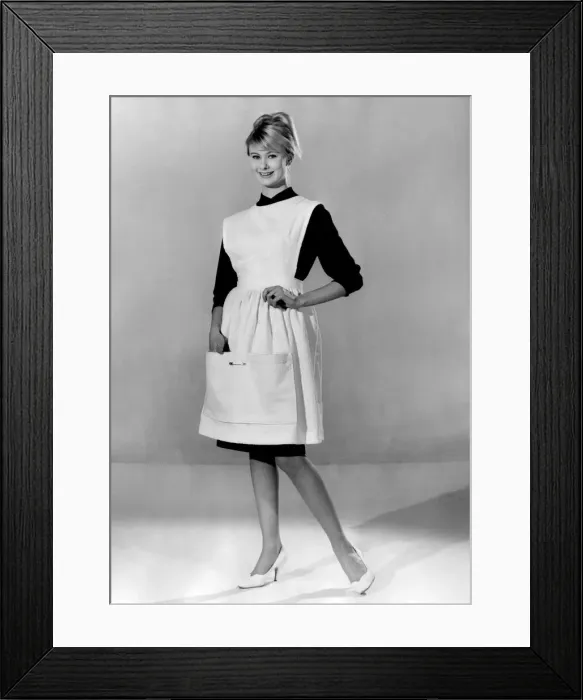 Framed Print : Jennifer Wilson wearing an apron over her black dress. March 1960 P009010 Framed Print : Jennifer Wilson wearing an apron over her black dress. March 1960 P009010