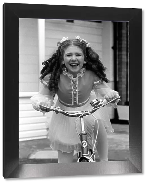Child star Bonnie Langford at home on bicycle 1975