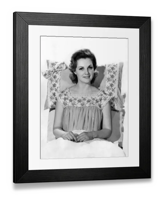 Framed Print : Model Roma Reeves wearing nightdress sitting up on the bed. August 1961 P008745