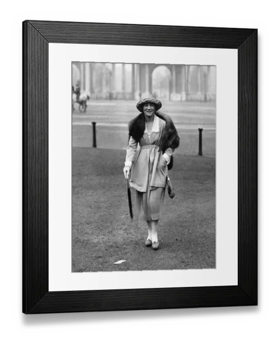 Framed Print : Woman wearing a fur stole over her coat with matching trousers Framed Print : Woman wearing a fur stole over her coat with matching trousers