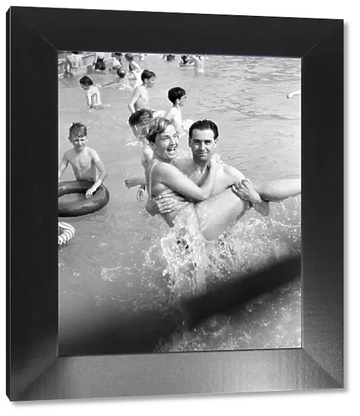 Rhyl bathing pool. Pauline Jones, 23, of Rhyl in the arms of her brother-in-law John