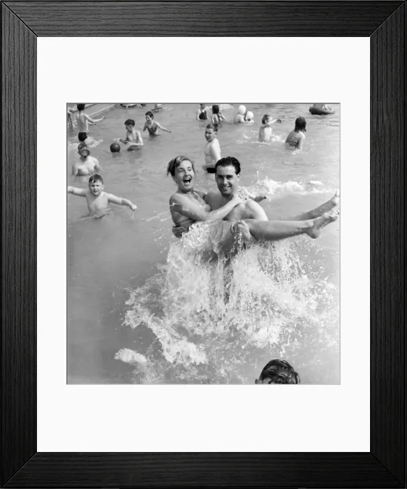 Framed Print : Rhyl bathing pool. Pauline Jones, 23, of Rhyl in the arms of her brother-in-law John