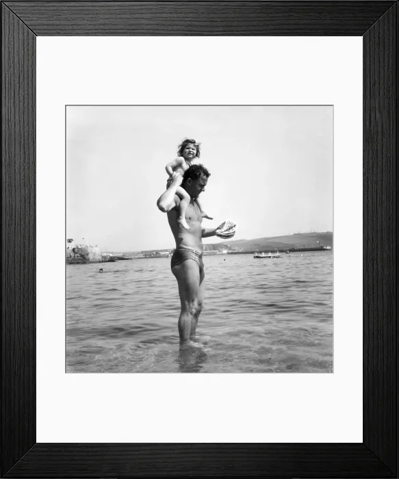 Framed Print : Families on the beach at Plymouth Man paddling in the sea with his daughter Framed Print : Families on the beach at Plymouth Man paddling in the sea with his daughter