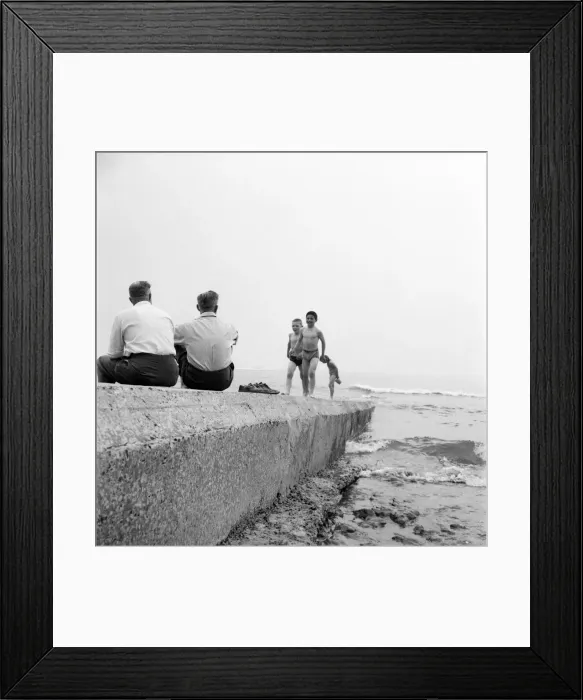 Framed Print : Holidaymakers on a sewerage pipe on the beach at Tynemouth near Newcastle Upon Tyne Framed Print : Holidaymakers on a sewerage pipe on the beach at Tynemouth near Newcastle Upon Tyne