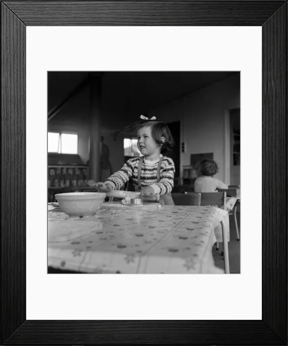 Framed Print : Young girl rolling out dough in cookery class at Cookham Nursery School Framed Print : Young girl rolling out dough in cookery class at Cookham Nursery School