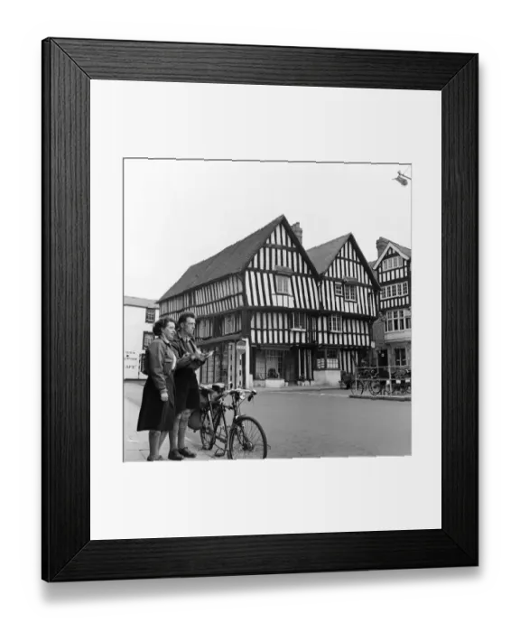 Framed Print : Man and woman sightseeing in an English town with Tudor style houses. October 1952 C5252 Framed Print : Man and woman sightseeing in an English town with Tudor style houses. October 1952 C5252