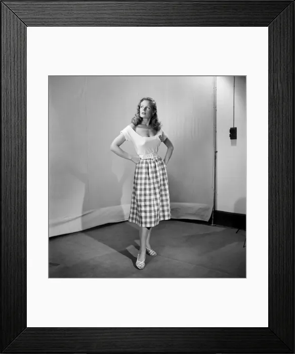 Framed Print : Woman wearing checked checked skirt and white short sleeved top