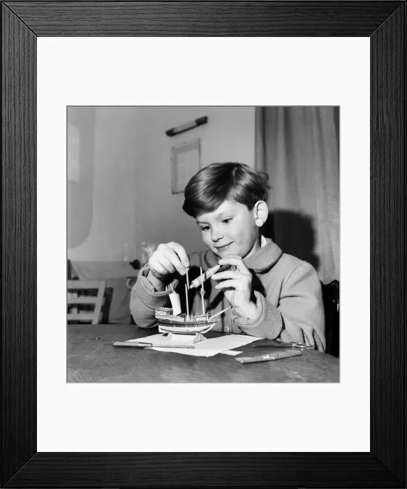 Framed Print : Young boy making a model replica of the HMS Victory, the ship of Lord Horatio Nelson Framed Print : Young boy making a model replica of the HMS Victory, the ship of Lord Horatio Nelson