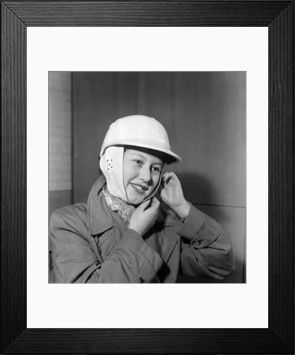 Framed Print : Woman strapping on her crash helmet. October 1952 C5018 Framed Print : Woman strapping on her crash helmet. October 1952 C5018