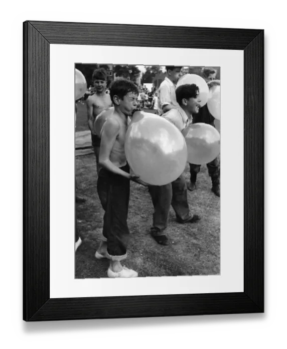 Framed Print : Toys Balloons: Peter Ash blowing up his balloons as part of a obstacle race Framed Print : Toys Balloons: Peter Ash blowing up his balloons as part of a obstacle race