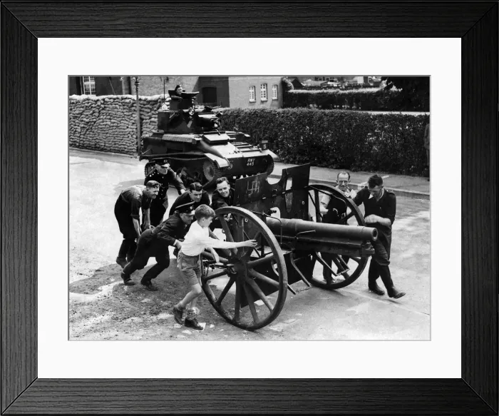 Framed Print : A souvenir of World War One, a German Howitzer being pushed to the scrap heap for metal Framed Print : A souvenir of World War One, a German Howitzer being pushed to the scrap heap for metal
