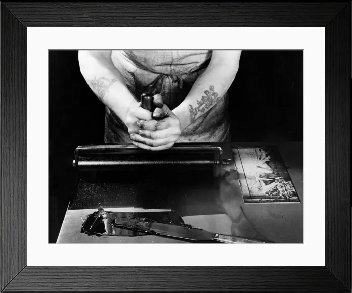 Framed Print : A Daily Mirror photographic engraver inks a plate so he can check his work before passing Framed Print : A Daily Mirror photographic engraver inks a plate so he can check his work before passing
