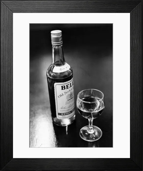 Framed Print : A bottle of Bells whisky and a poured glass beside it. April 1983 P009582 Framed Print : A bottle of Bells whisky and a poured glass beside it. April 1983 P009582