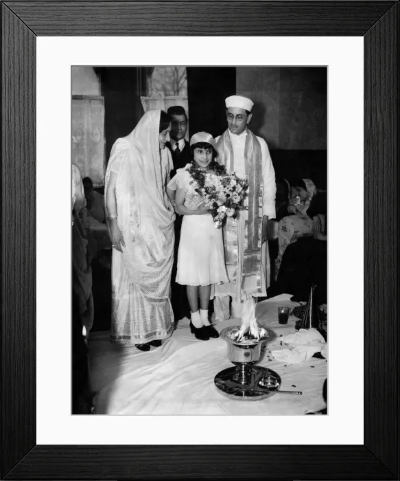 Framed Print : Girl with priest and parents in front of fire symbol during confirmation