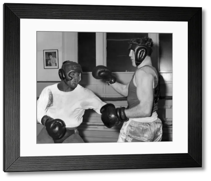 Framed Print : Ouch ! That hurt, grunts Allan Hands of Blackpool as Joe Bygraves of Birkenhead digs home Framed Print : Ouch ! That hurt, grunts Allan Hands of Blackpool as Joe Bygraves of Birkenhead digs home