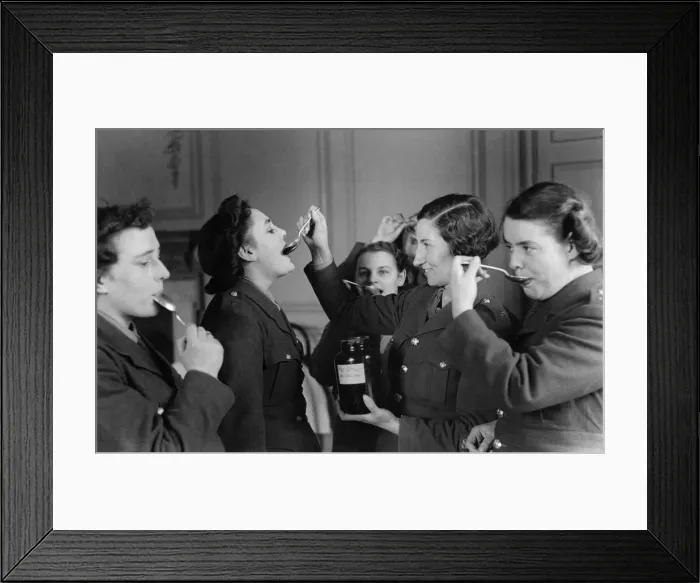 Framed Print : A spoonful of sugar makes the medicine go down. ATS girls seen here taking cod Framed Print : A spoonful of sugar makes the medicine go down. ATS girls seen here taking cod
