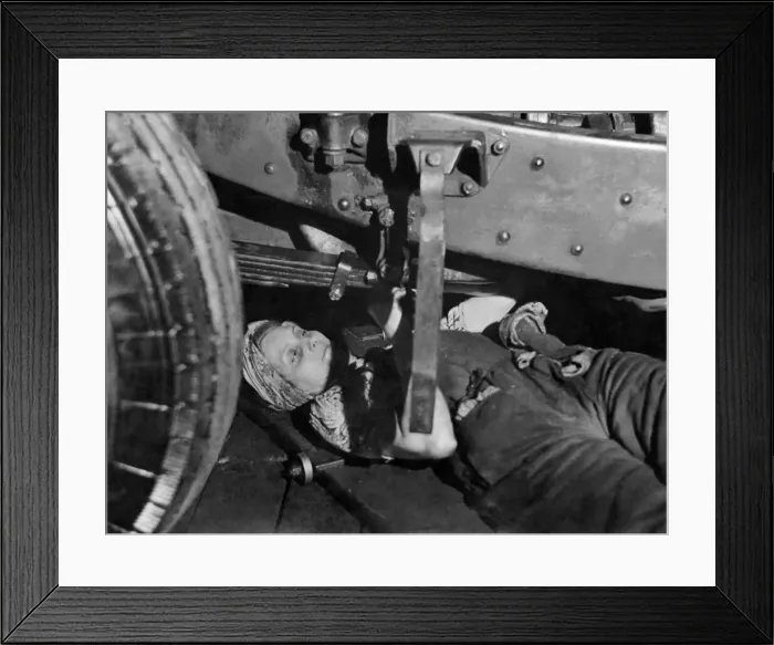 Framed Print : A women bus mechanic at work underneath the vehicle. June 1941 P010117 Framed Print : A women bus mechanic at work underneath the vehicle. June 1941 P010117