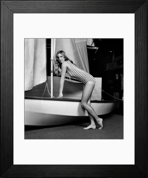 Framed Print : Top glamour model Stephanie McLean posing next to a sailboat January 1975