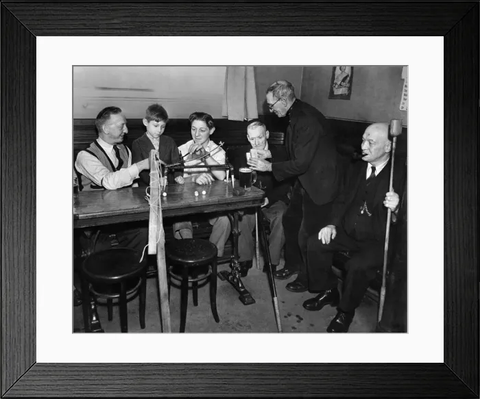 Framed Print : Mr. Herbert Robinson and his 17 year old son Colin, explaining the working of Framed Print : Mr. Herbert Robinson and his 17 year old son Colin, explaining the working of
