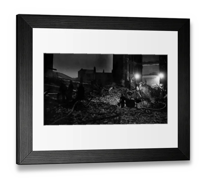 Framed Print : Firemen were still playing their hose on to the smouldering ruins of a factory while