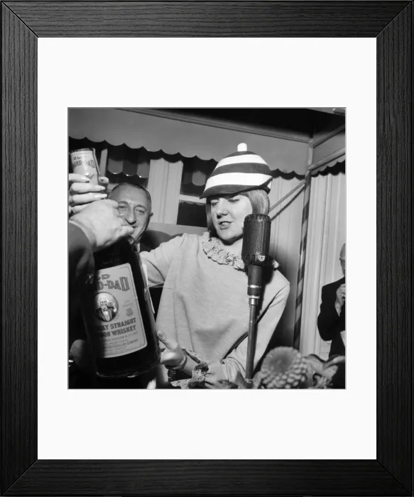 Framed Print : V. C. G. B. Luncheon: Cilla Black holding large whiskey bottle Framed Print : V. C. G. B. Luncheon: Cilla Black holding large whiskey bottle
