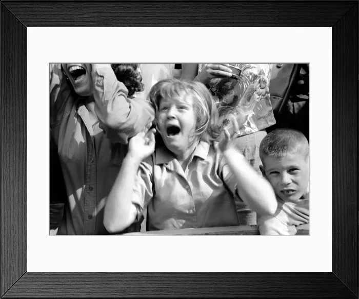 Framed Print : Screaming Beatles fans cheer for their idols on the streets of New York City