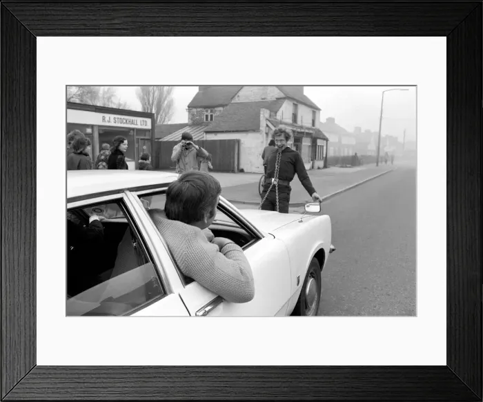 Framed Print : Strongman Reg Morris pulls car and passengers with his teeth. February 1975 75-00777 Framed Print : Strongman Reg Morris pulls car and passengers with his teeth. February 1975 75-00777