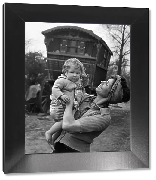 Gypsy woman with child pose outside their caravan. July 1944 P007205