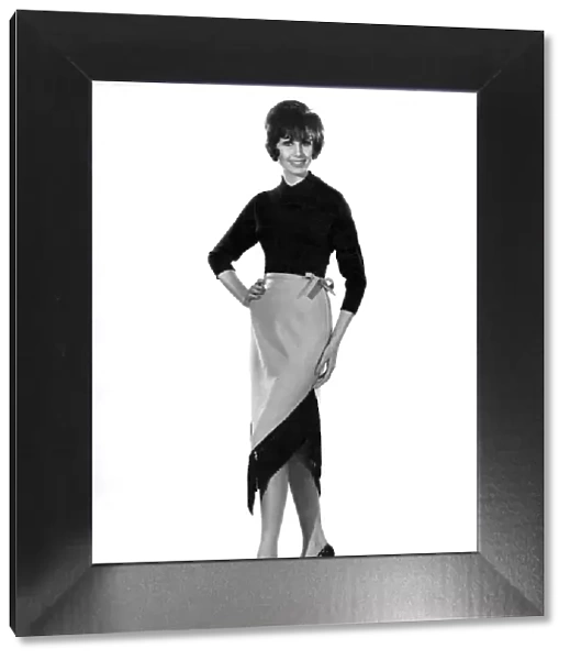 Reveille Fashions 1961: Stella Grove modelling split leg dress and apron
