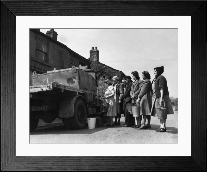 Framed Print : The housewives of Tottington queue up for their daily ration of water Framed Print : The housewives of Tottington queue up for their daily ration of water