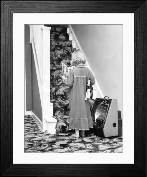 Framed Print : A young girl ready for bedtime with her story book and doll Framed Print : A young girl ready for bedtime with her story book and doll
