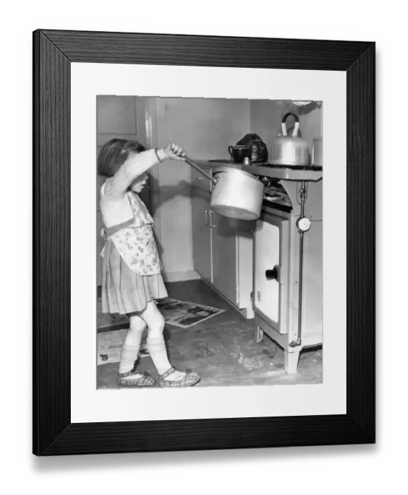 Framed Print : This young girl wants to cook like mother, however dangers lurk everywhere for Framed Print : This young girl wants to cook like mother, however dangers lurk everywhere for