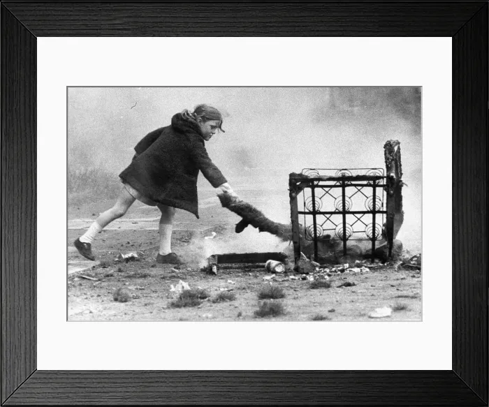 Framed Print : A young girl risks injury playing with fire on wasteland 01  /  11  /  72circa