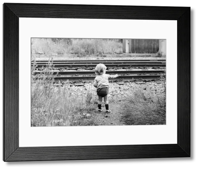 Framed Print : A child toddles terrifyingly close to an unprotected railway track Framed Print : A child toddles terrifyingly close to an unprotected railway track