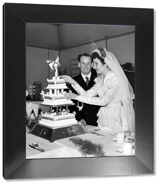 The bride and groom cut the cake. October 1953 D6213