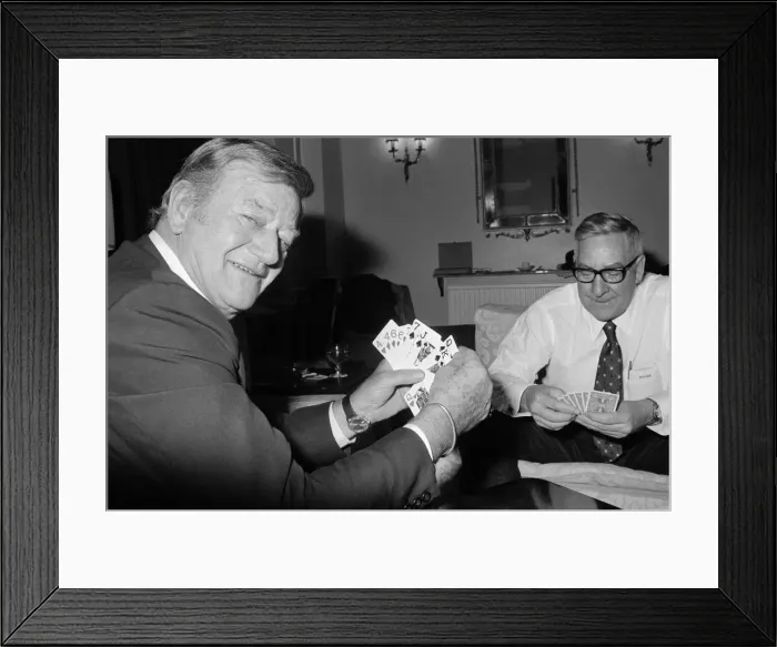 Framed Print : John Wayne pictured relaxing playing cards in his suite at The Connaught Hotel, Mayfair Framed Print : John Wayne pictured relaxing playing cards in his suite at The Connaught Hotel, Mayfair