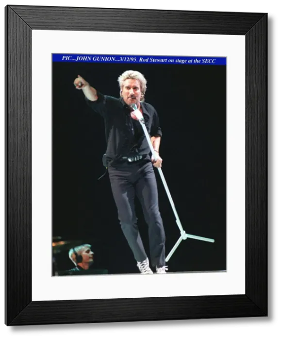 Framed Print : Rod Stewart dancing with the mike on stage at the SECC in Glasgow pointing