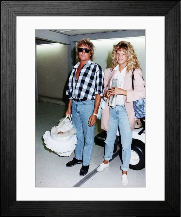 Framed Print : Rod Stewart and Wife Rachel leaves Heathrow Airport Aug 1992 Framed Print : Rod Stewart and Wife Rachel leaves Heathrow Airport Aug 1992