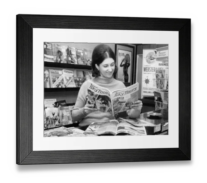 Framed Print : Susan Slater pores over the holiday brochures in a Newcastle Travel Agency